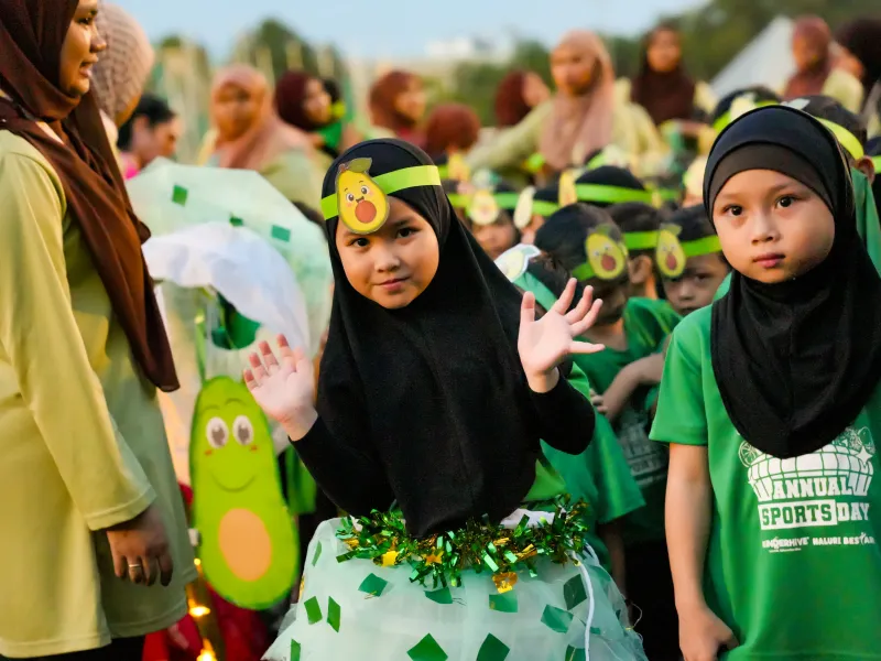 Children wearing green costumes during the KinderHive and Naluri Bestari Sports Day parade
