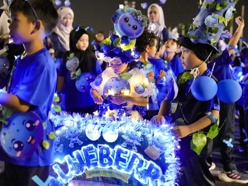 Children wearing illuminated blue space-themed costumes during Annual Sports Day 2026