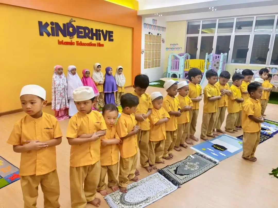 KinderHive preschool children performing prayer in the classroom