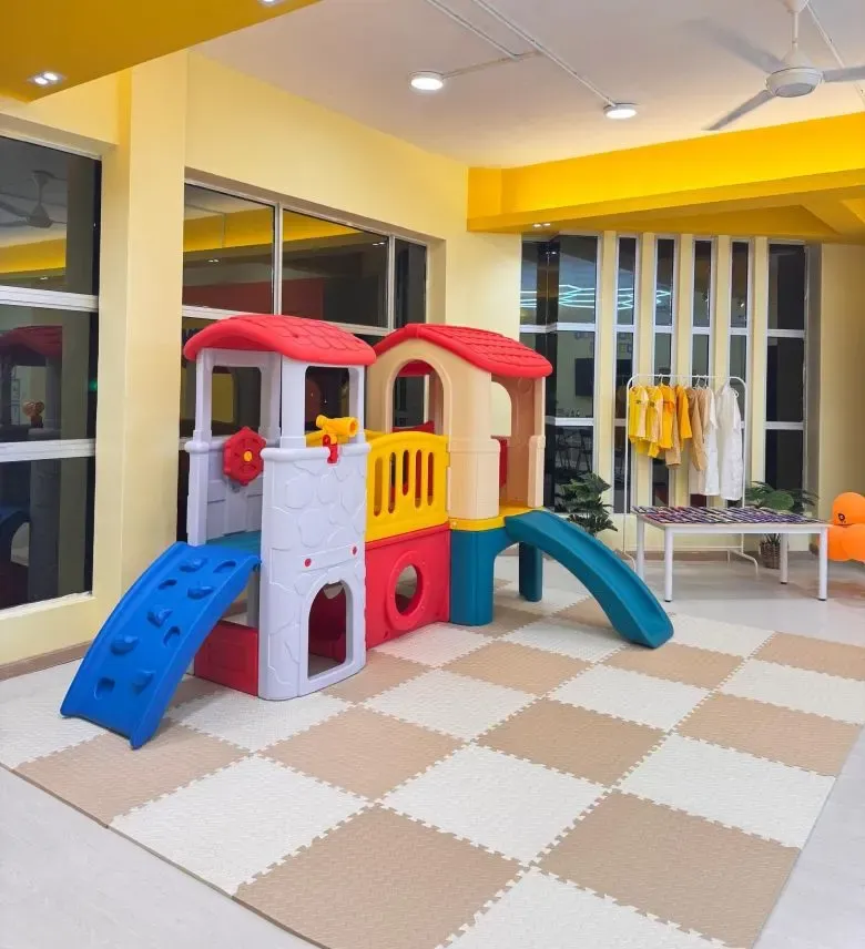 KinderHive indoor playground with slides and playhouse for preschool children