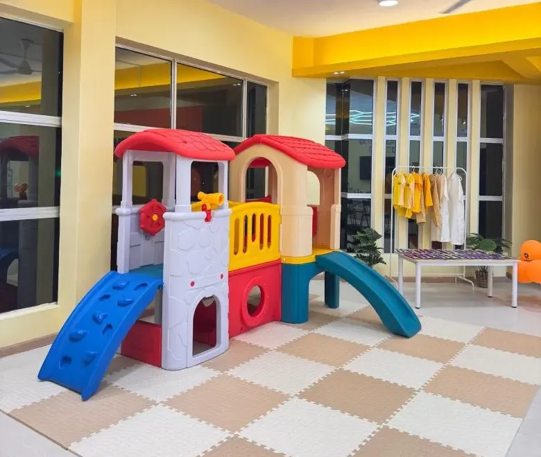KinderHive indoor playground with slides and playhouse for preschool children