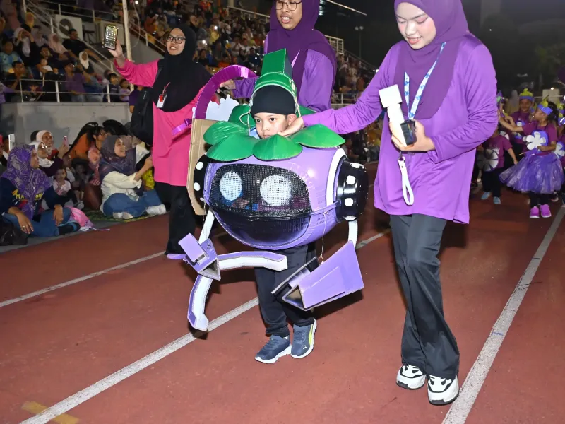 Child participating in the Sports Day parade in a colourful space-ranger costume