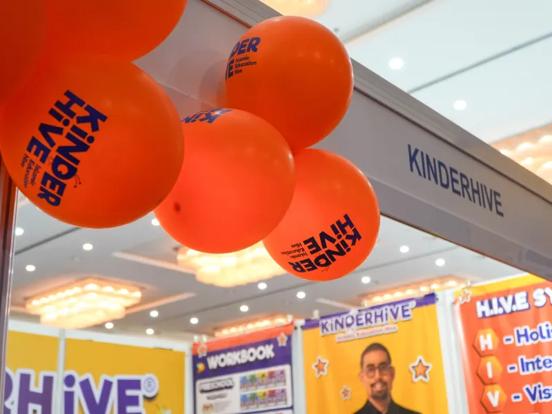 Orange KinderHive balloons at the KinderHive booth during ECEE 2026 at IDCC Shah Alam